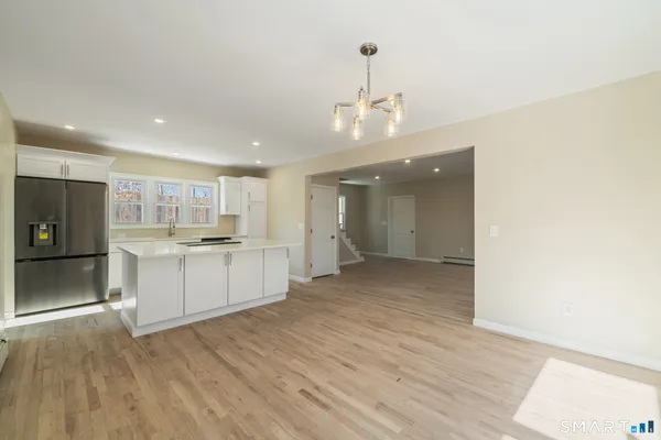 a view of kitchen with center island and stainless steel appliances