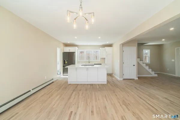 a view of a kitchen with a sink and wooden floor