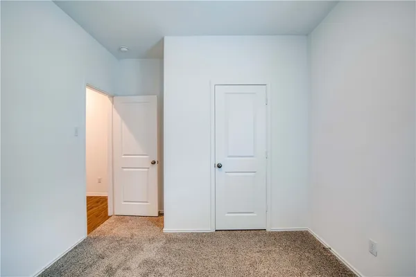 an empty room with closet area