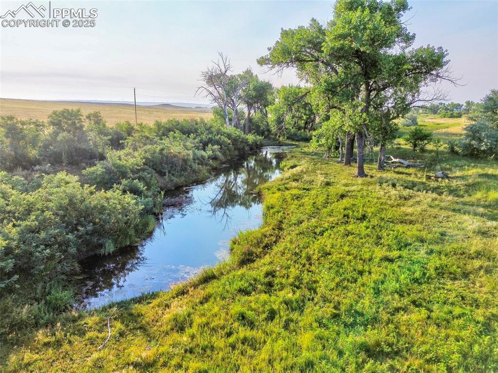 11950 Log Road Peyton, CO 80831 - Photo 1 of 17 a view of a lake with a building in the background