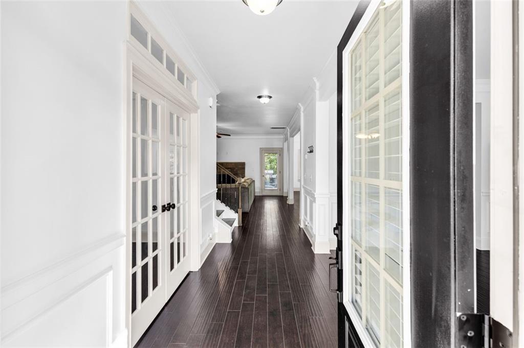 908 Rainsong Court Braselton, GA 30517 - Photo 12 of 79 a view of a hallway with wooden floor and staircase