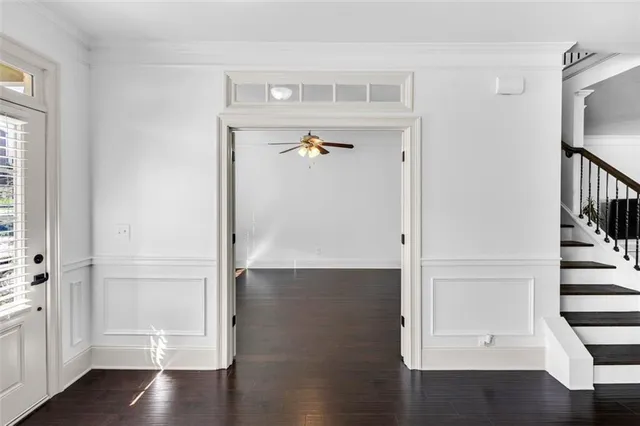 a view of entryway with wooden floor and stairs