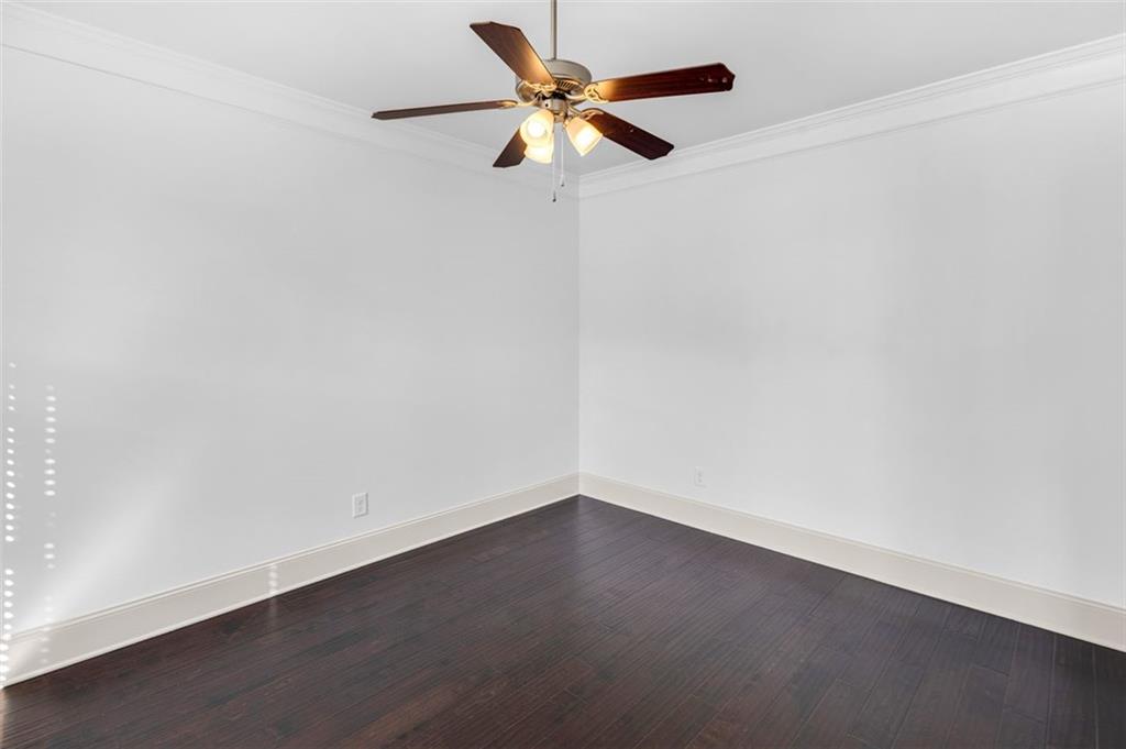 908 Rainsong Court Braselton, GA 30517 - Photo 14 of 79 an empty room with a fan and a ceiling fan