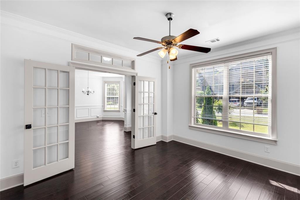 908 Rainsong Court Braselton, GA 30517 - Photo 15 of 79 a view of an empty room with wooden floor and window