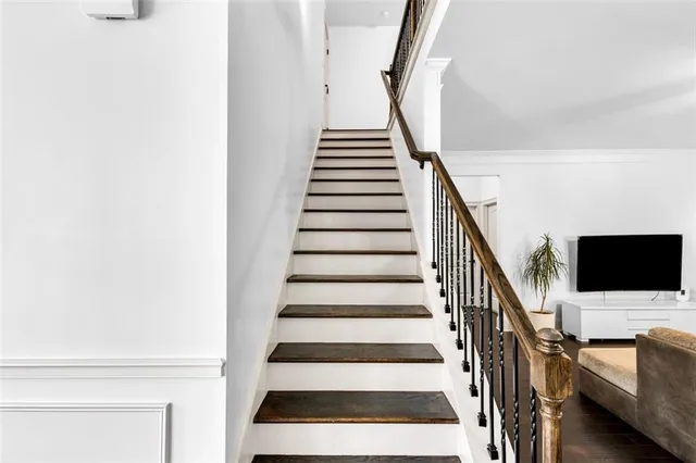 a kitchen with stainless steel appliances granite countertop a sink a stove a refrigerator cabinets and a window