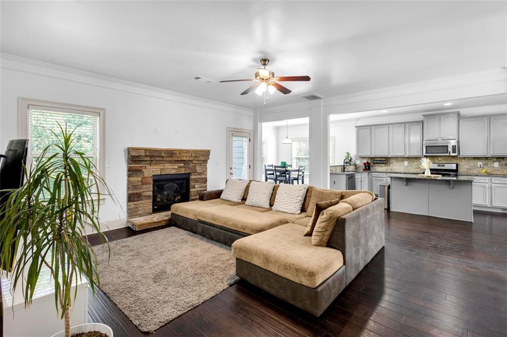908 Rainsong Court Braselton, GA 30517 - Photo 20 of 79 a living room with furniture a fireplace and a chandelier