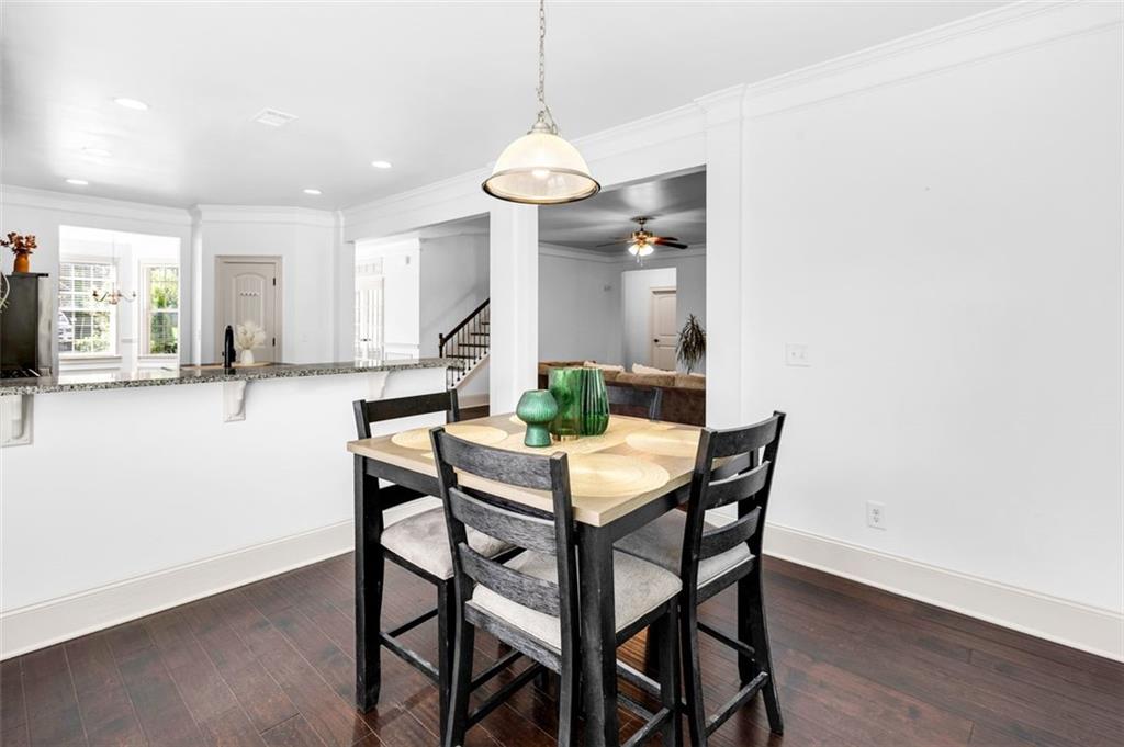 908 Rainsong Court Braselton, GA 30517 - Photo 26 of 79 a view of a dining room with furniture and wooden floor