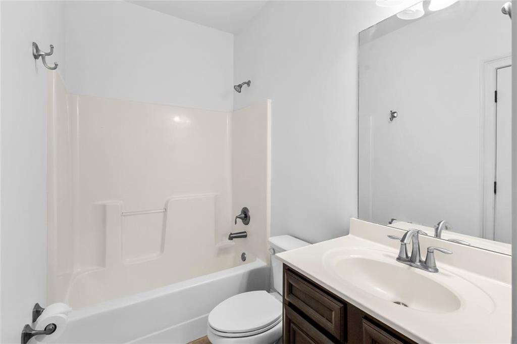 908 Rainsong Court Braselton, GA 30517 - Photo 29 of 79 a bathroom with a sink a toilet and shower