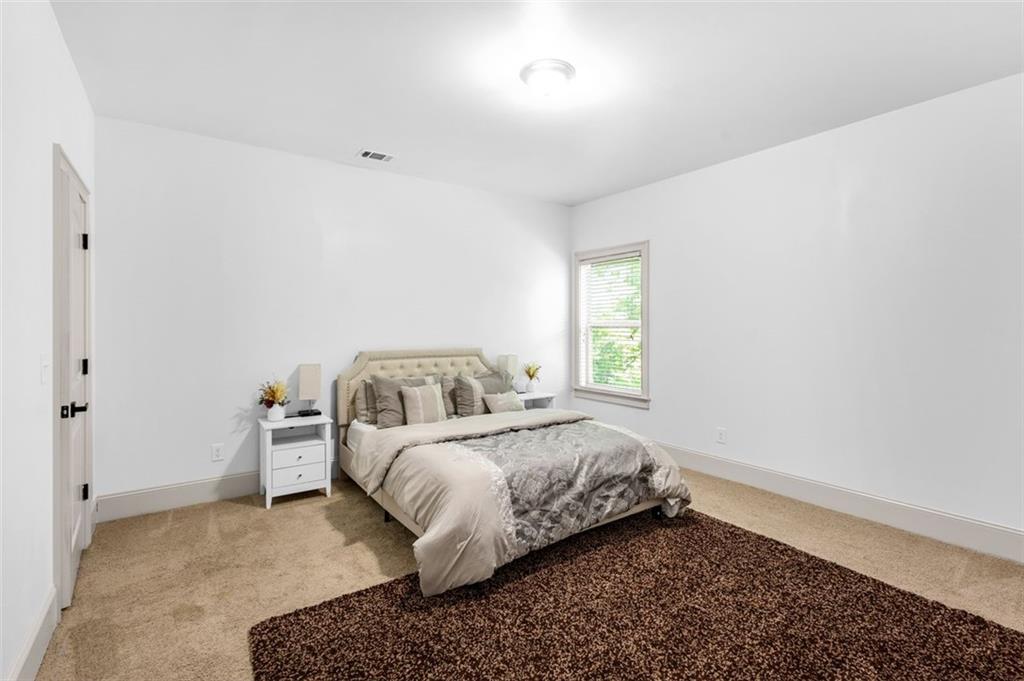 908 Rainsong Court Braselton, GA 30517 - Photo 30 of 79 a bedroom with a bed and a window