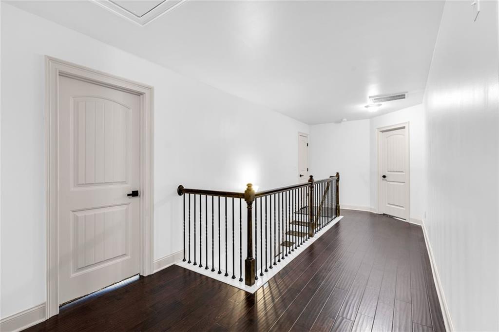 908 Rainsong Court Braselton, GA 30517 - Photo 40 of 79 a view of a hallway with wooden floor