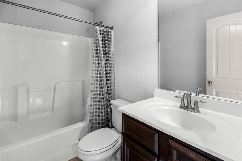 908 Rainsong Court Braselton, GA 30517 - Photo 50 of 79 a bathroom with a sink a toilet and shower