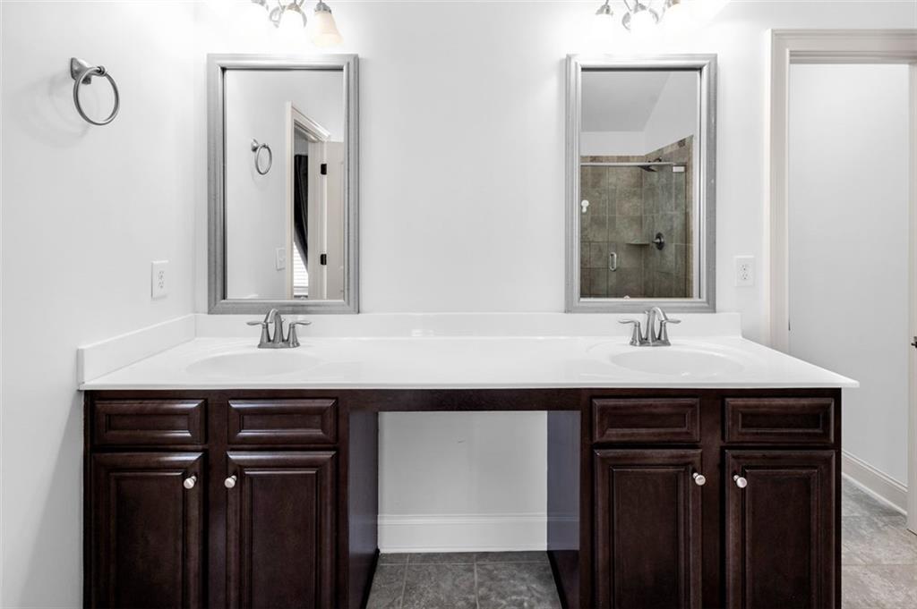 908 Rainsong Court Braselton, GA 30517 - Photo 57 of 79 a bathroom with a sink double vanity and a mirror