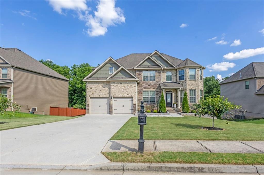908 Rainsong Court Braselton, GA 30517 - Photo 6 of 79 a front view of a house with a yard