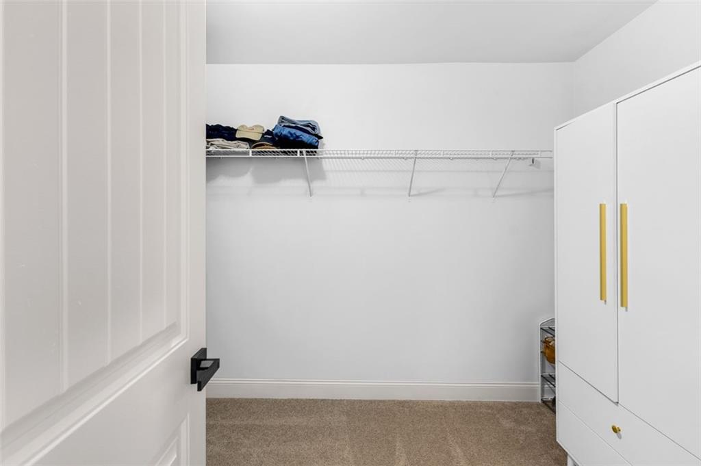 908 Rainsong Court Braselton, GA 30517 - Photo 63 of 79 a view of walk in closet with clothes and shoes