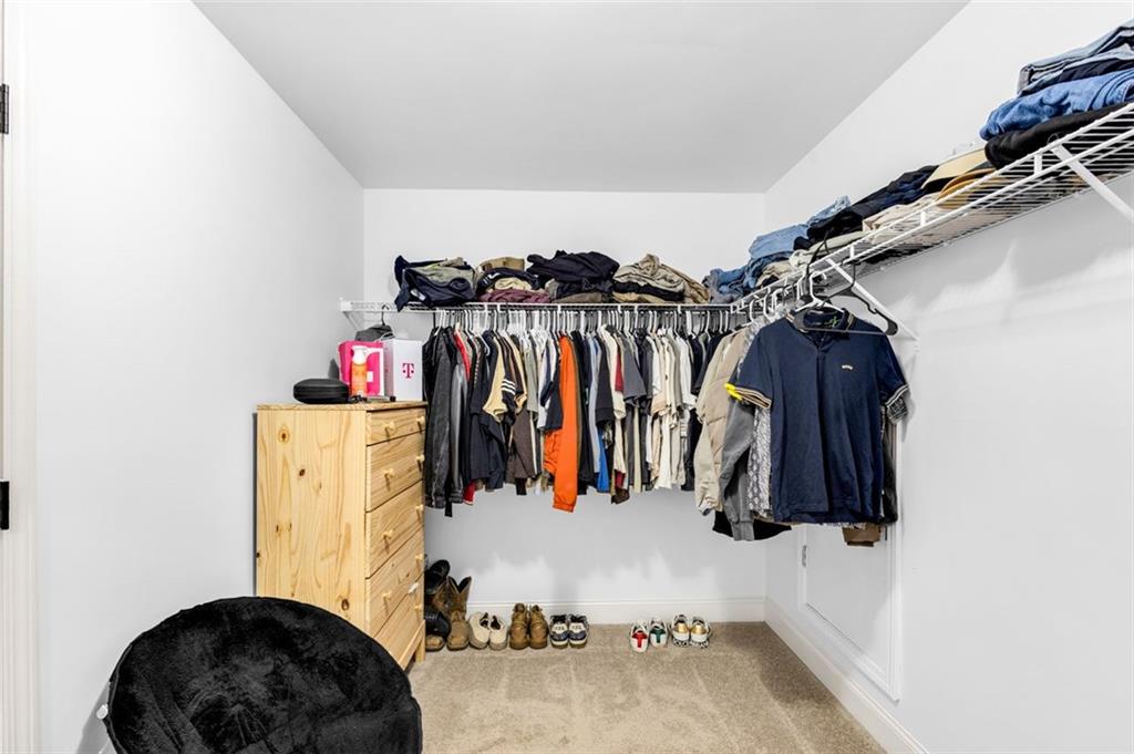 908 Rainsong Court Braselton, GA 30517 - Photo 64 of 79 a view of walk in closet with clothes and shoes
