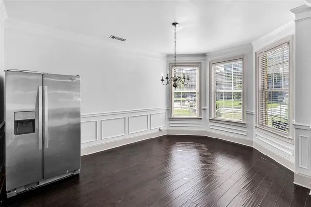 an empty room with a fan and a ceiling fan