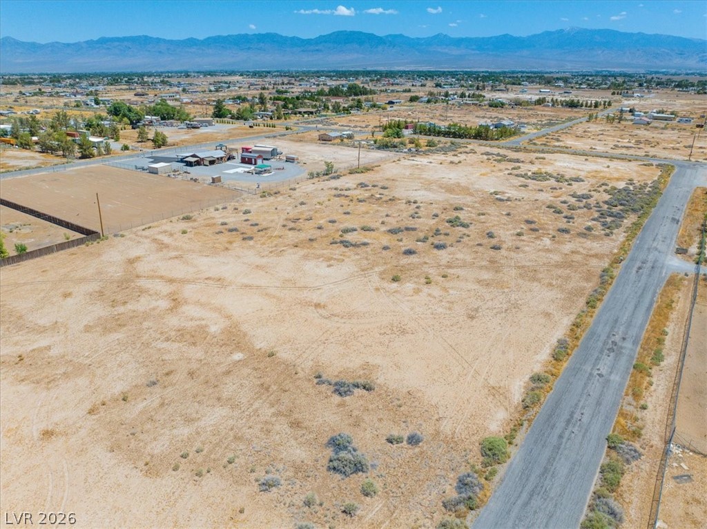 4610 Lawrence Road Pahrump, NV 89048 - Photo 31 of 42 A vast, undeveloped parcel presents clear mountain views under an open sky.