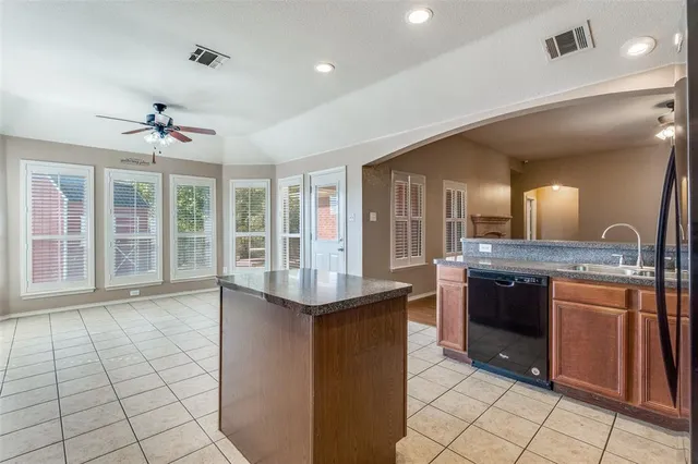a large kitchen with stainless steel appliances granite countertop a sink and a stove
