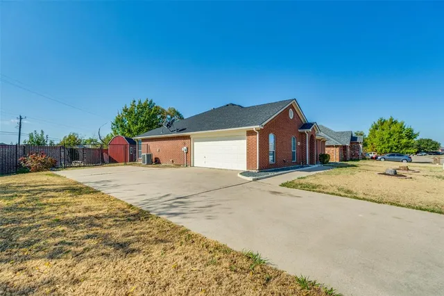 a house with a yard and a large tree