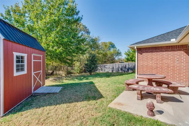 a view of a backyard with sitting area