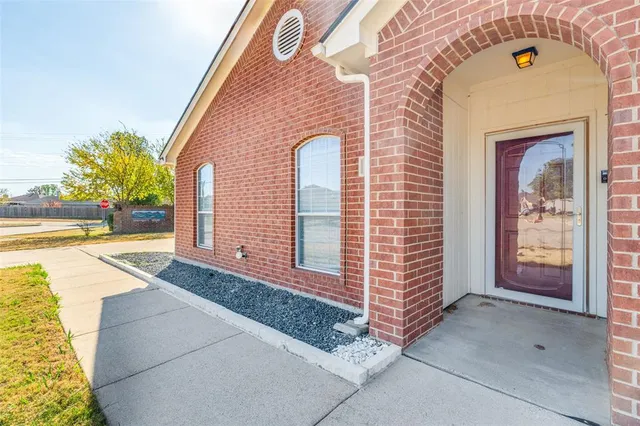 a view of a brick house with many windows