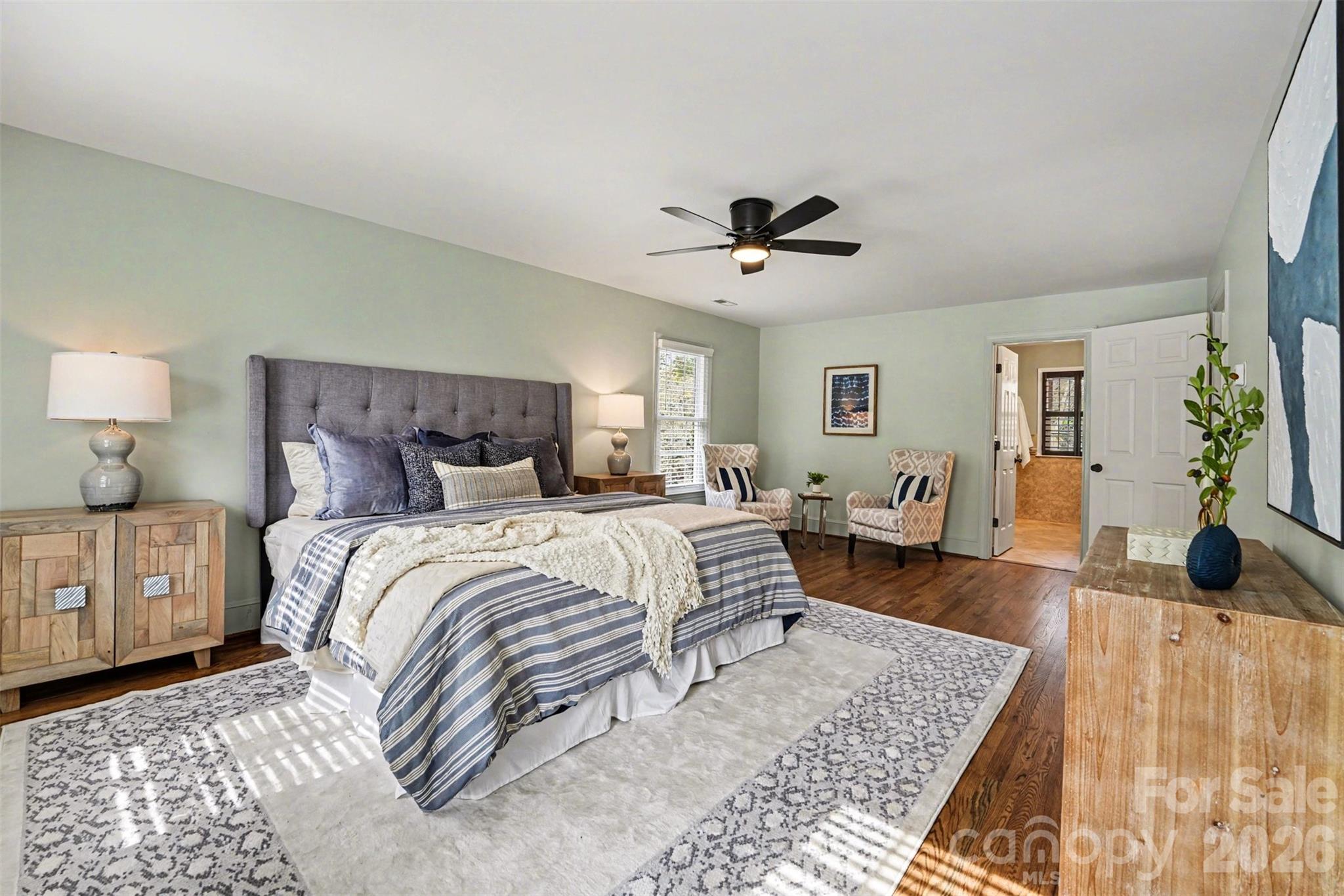 5606 Hillingdon Road Charlotte, NC 28226 - Photo 17 of 41 a bedroom with a large bed and a chandelier