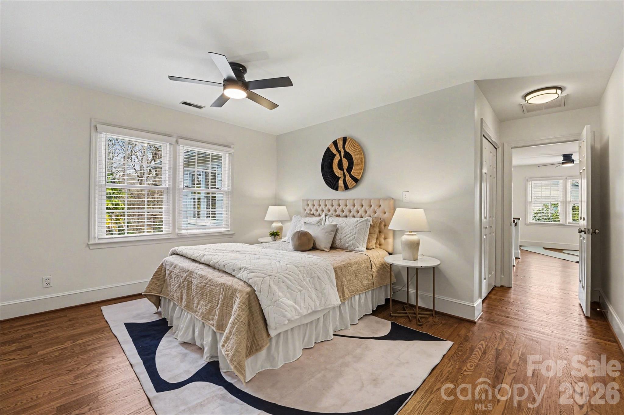 5606 Hillingdon Road Charlotte, NC 28226 - Photo 22 of 41 a spacious bedroom with a bed and wooden floor
