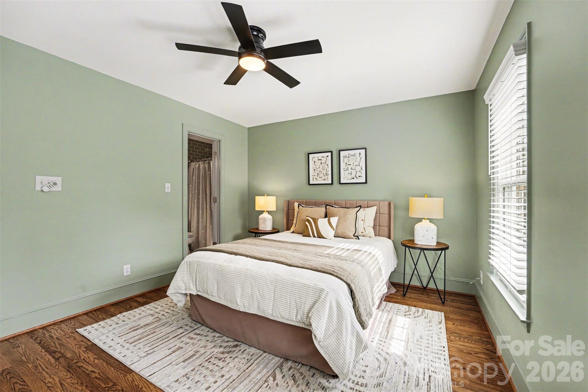 5606 Hillingdon Road Charlotte, NC 28226 - Photo 26 of 41 a bedroom with a large bed chandelier and a window