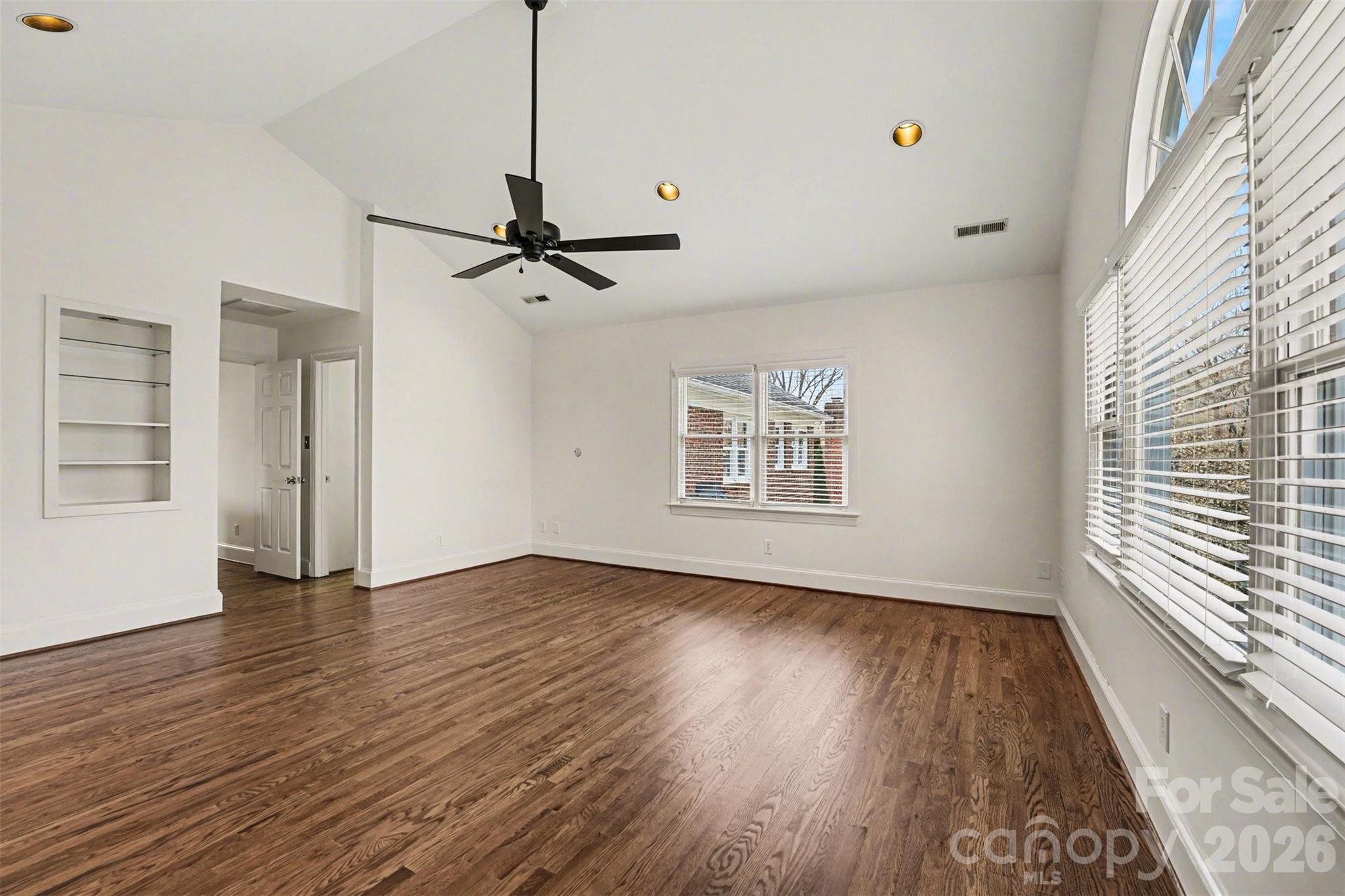 5606 Hillingdon Road Charlotte, NC 28226 - Photo 28 of 41 a view of an empty room with a window and wooden floor