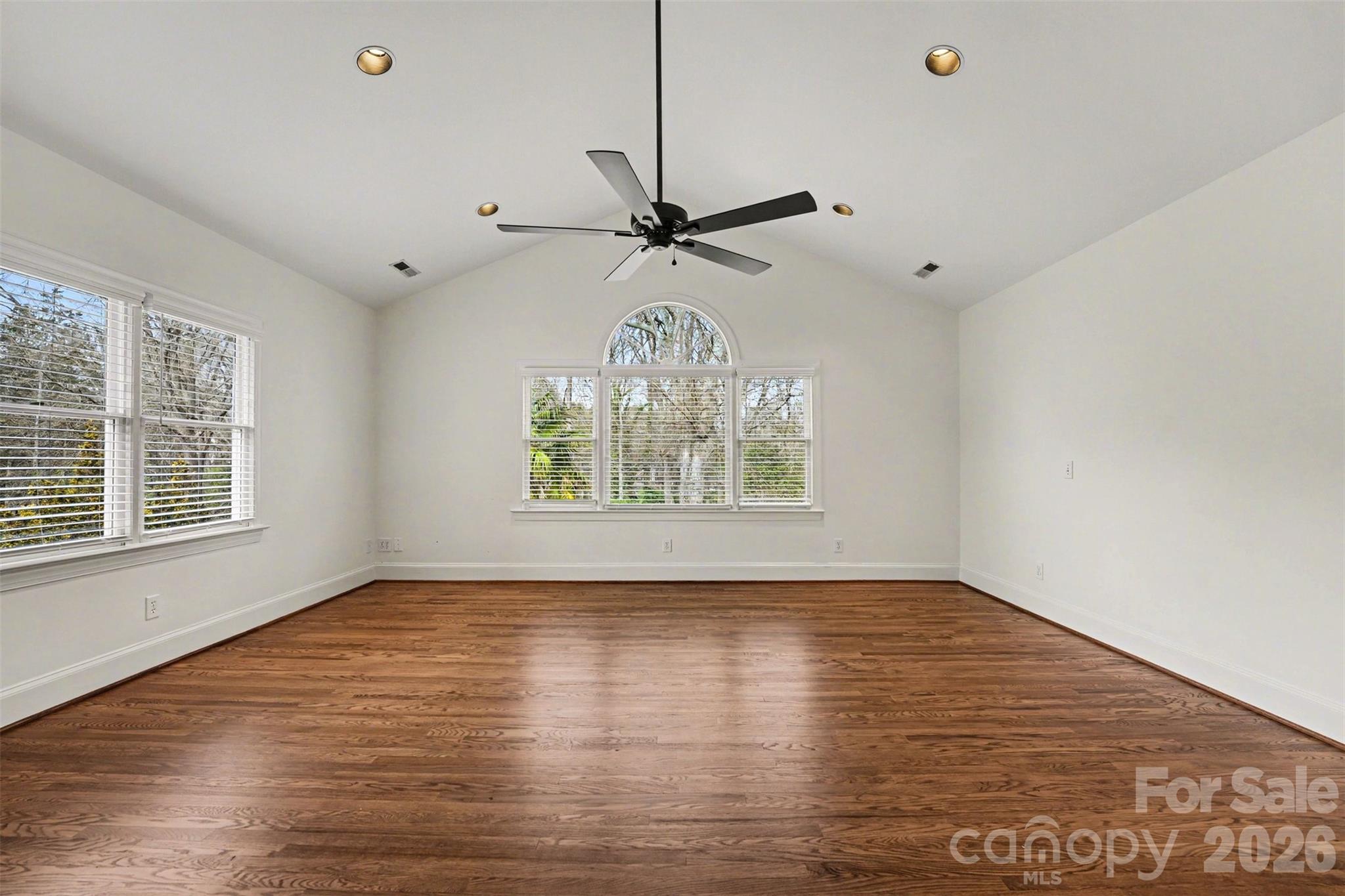 5606 Hillingdon Road Charlotte, NC 28226 - Photo 29 of 41 a view of an empty room with a window and wooden floor