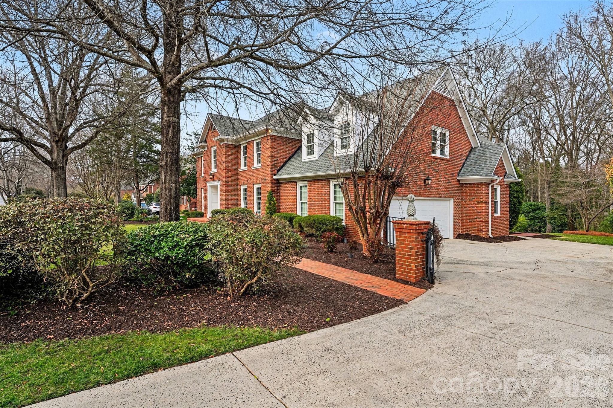 5606 Hillingdon Road Charlotte, NC 28226 - Photo 40 of 41 a front view of a house with a garden and trees