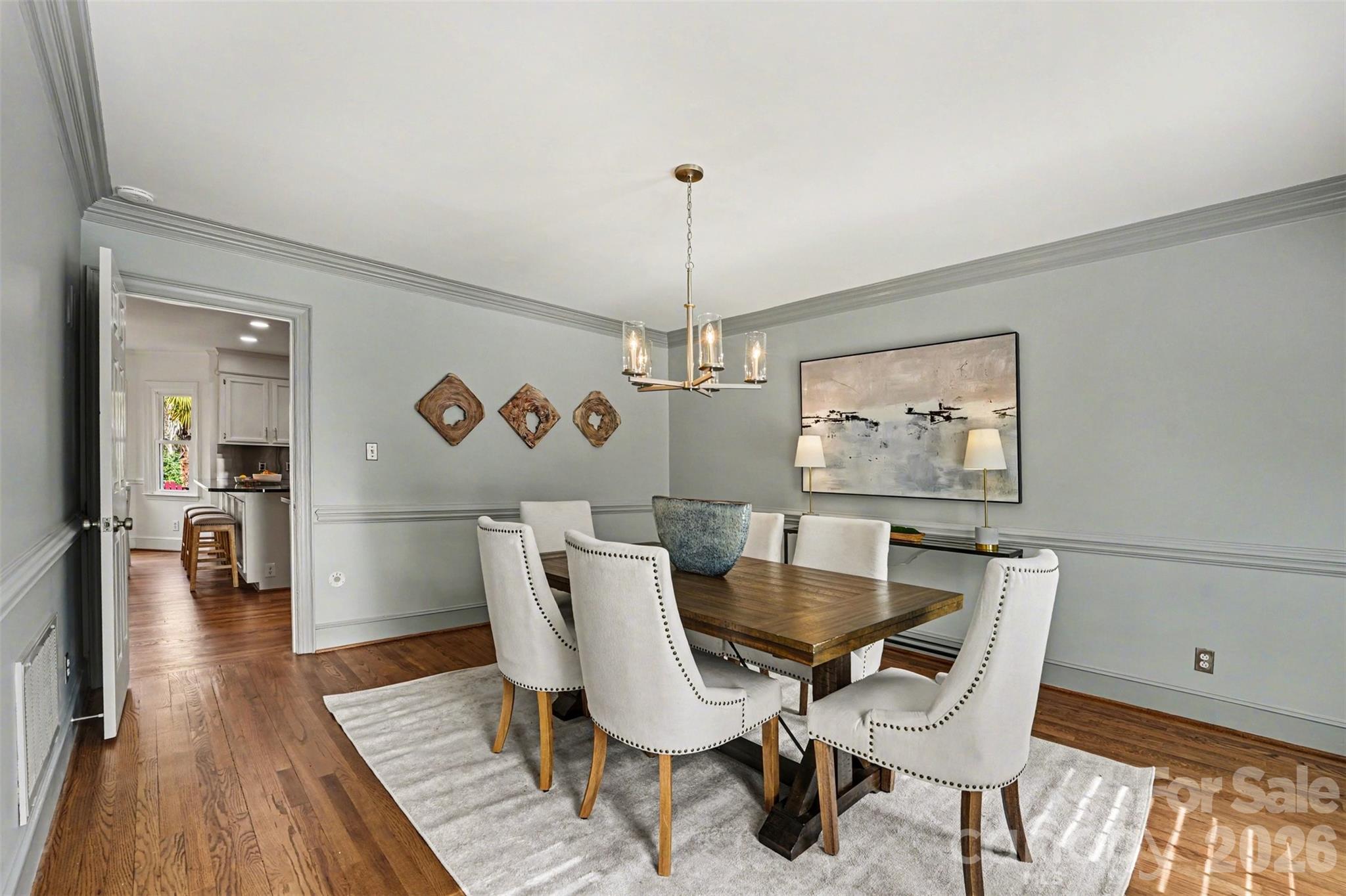 5606 Hillingdon Road Charlotte, NC 28226 - Photo 5 of 41 a dining room with furniture a rug and wooden floor
