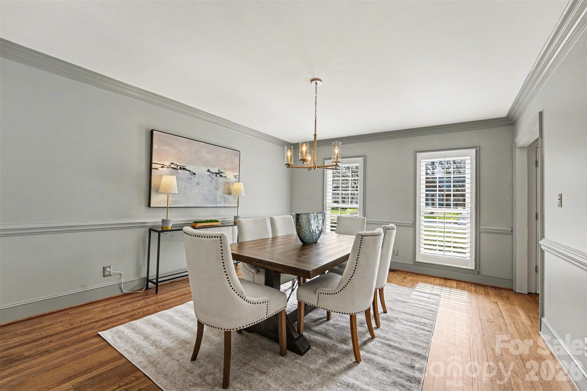 5606 Hillingdon Road Charlotte, NC 28226 - Photo 6 of 41 a dining room with furniture a chandelier and wooden floor