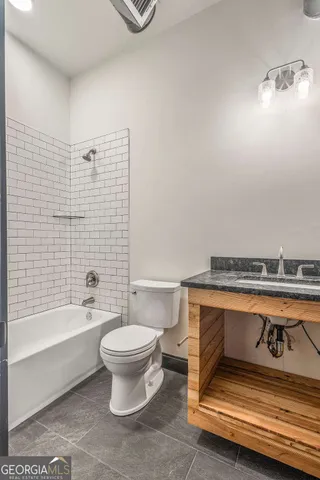 a bathroom with a toilet a sink and bathtub