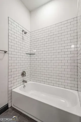 a bathroom with a bathtub and a shower