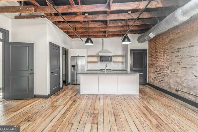 a view of kitchen with cabinets and wooden floor