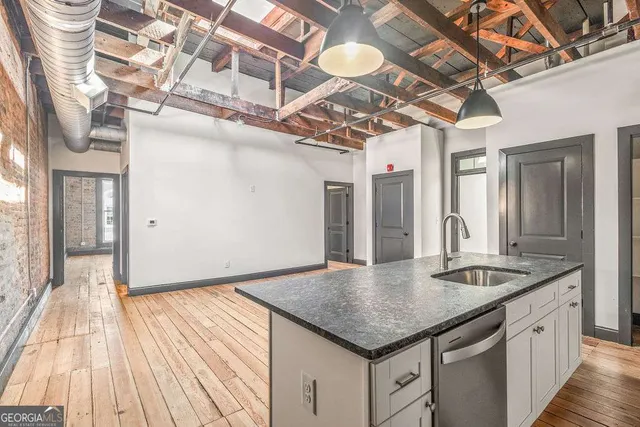 a kitchen with stainless steel appliances granite countertop a sink and cabinets