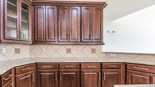 a kitchen with granite countertop stainless steel appliances a refrigerator and a sink