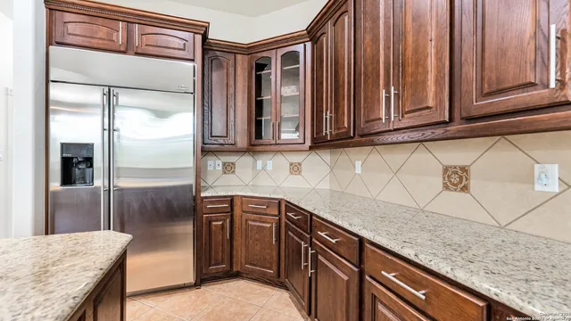 a kitchen with granite countertop a sink and a counter top space