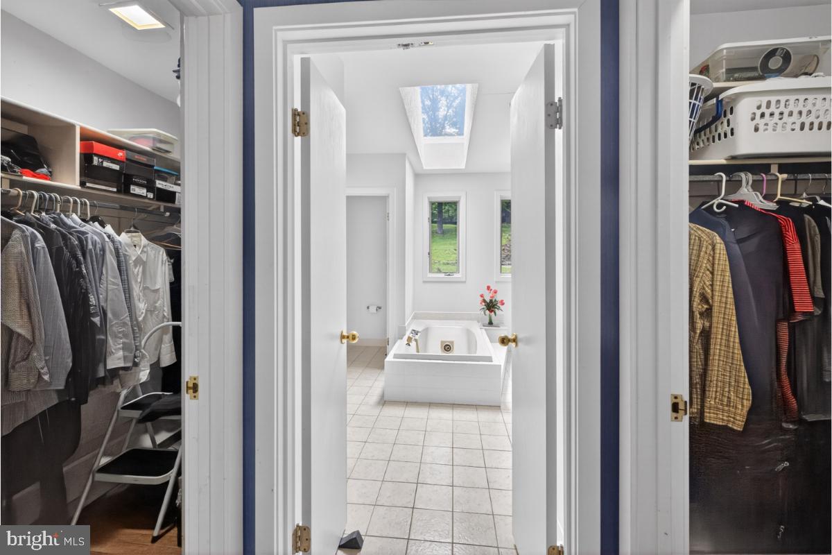 10320 Glen Road Potomac, MD 20854 - Photo 14 of 75 a view of walk in closet with clothes and shoes