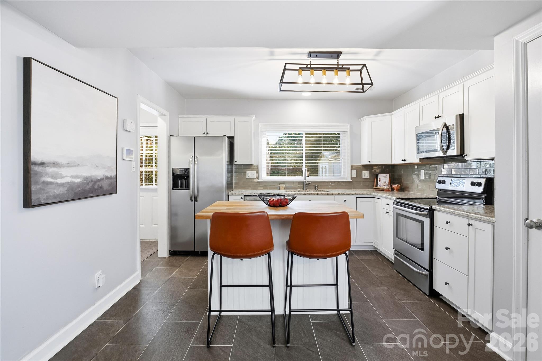 6409 Montpelier Road Charlotte, NC 28210 - Photo 14 of 46 a kitchen with stainless steel appliances granite countertop a stove a sink and a refrigerator