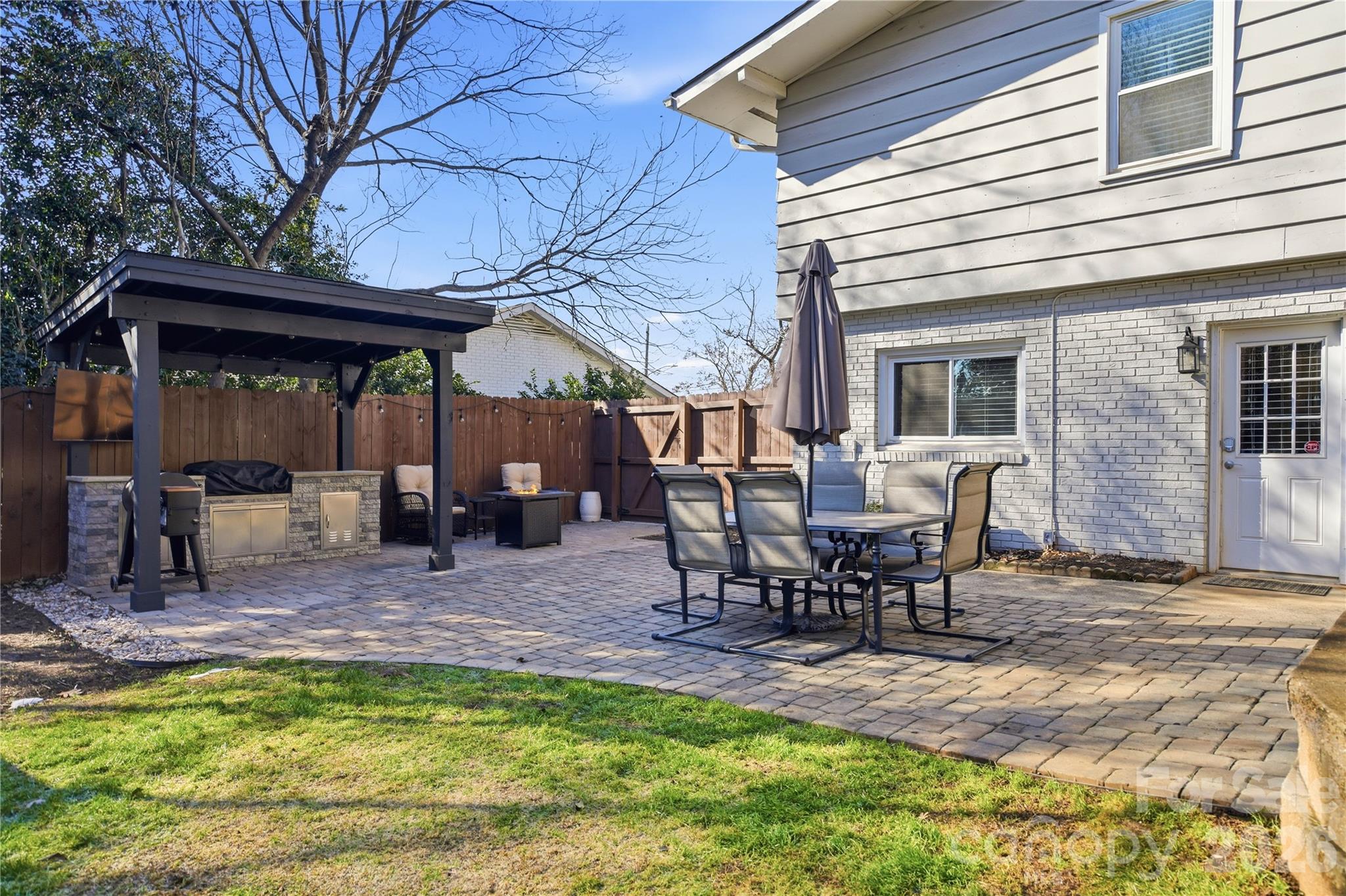 6409 Montpelier Road Charlotte, NC 28210 - Photo 37 of 46 a view of a backyard with table and chairs