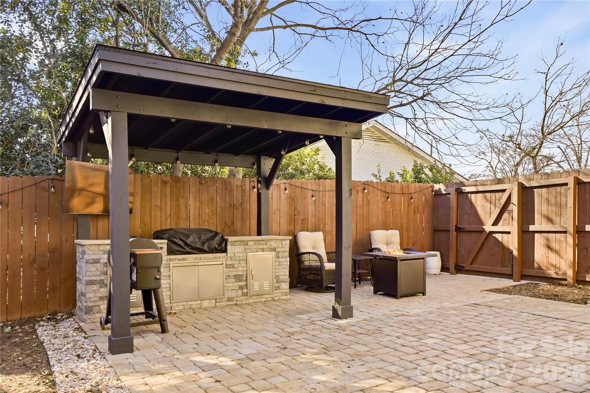 6409 Montpelier Road Charlotte, NC 28210 - Photo 39 of 46 a view of a patio with a table and chairs next to a yard