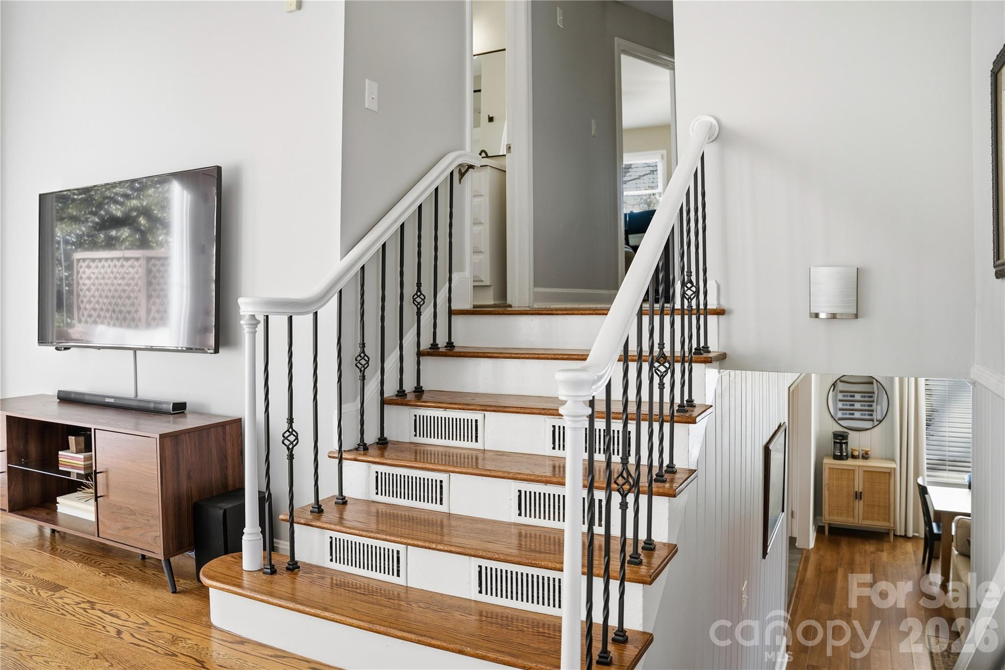 6409 Montpelier Road Charlotte, NC 28210 - Photo 7 of 46 a view of staircase with lots of frames on wall and a wooden floor