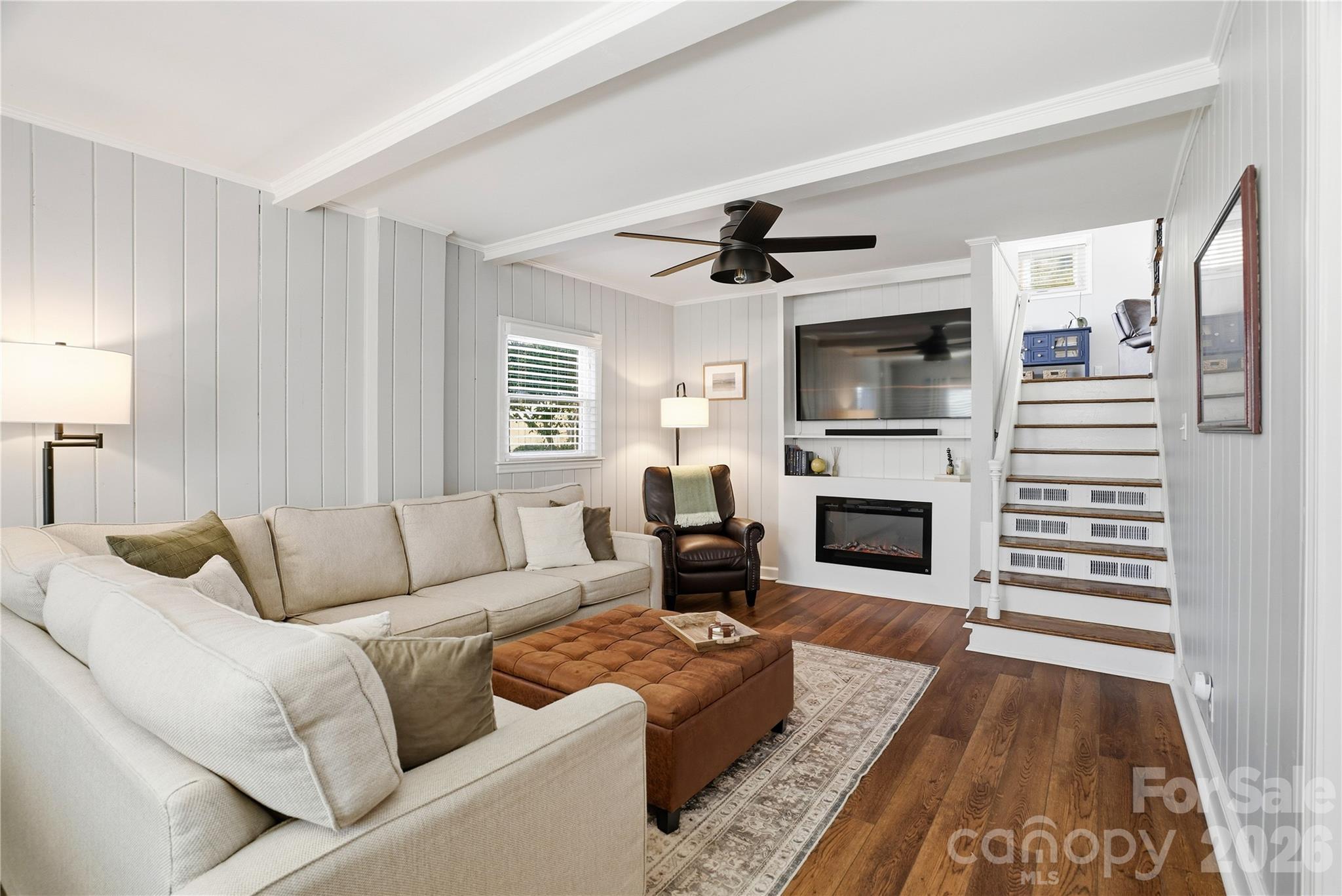 6409 Montpelier Road Charlotte, NC 28210 - Photo 9 of 46 a living room with furniture a fireplace and a flat screen tv