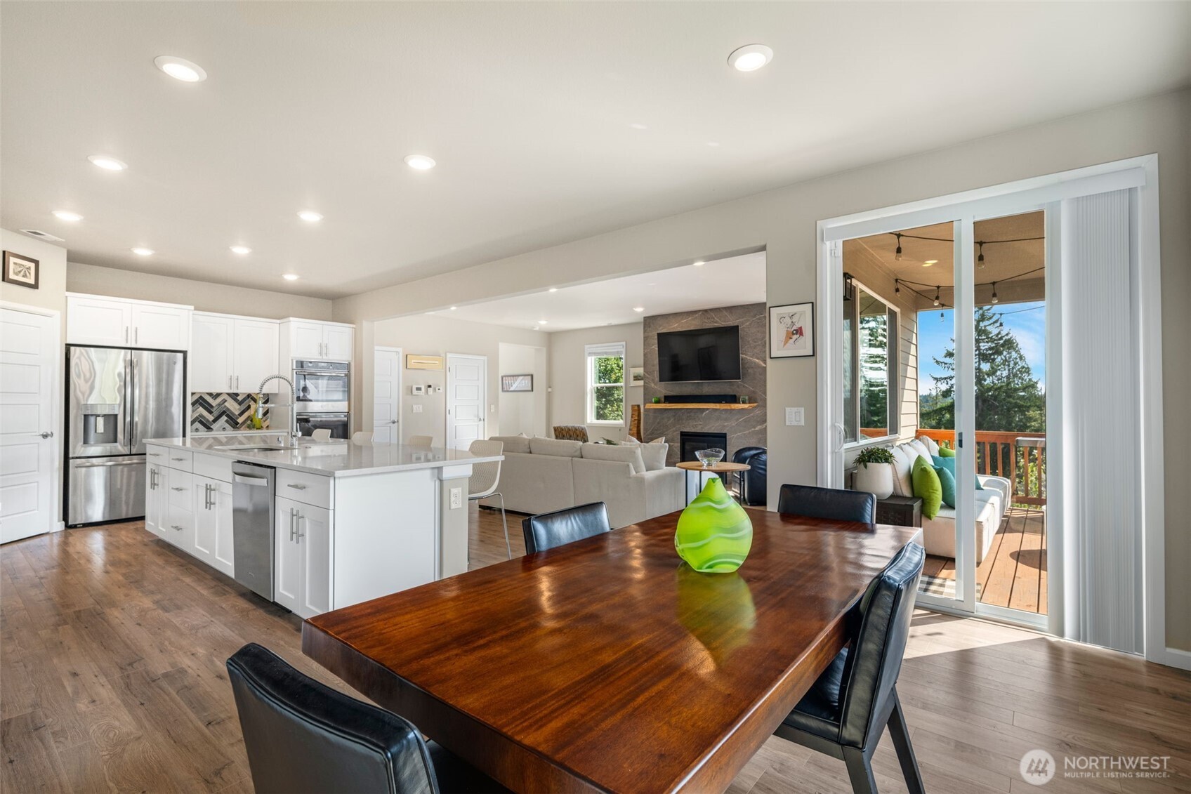 216 178th Street Southeast Bothell, WA 98012 - Photo 13 of 40 a kitchen with a dining table chairs and refrigerator