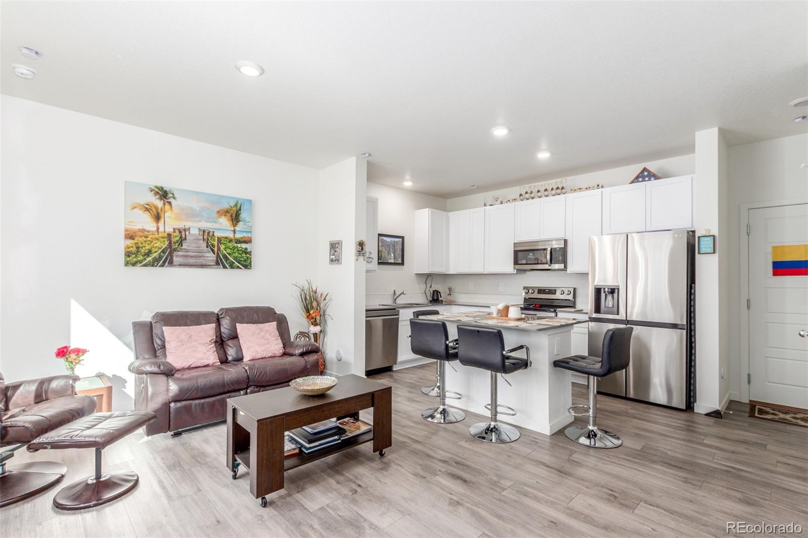 500 South Denver Avenue, Unit 7B Fort Lupton, CO 80621 - Photo 11 of 31 a living room with stainless steel appliances furniture and a kitchen view