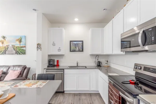 a kitchen with stainless steel appliances a stove a sink and a refrigerator