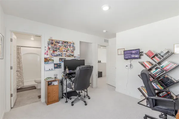 a view of a workspace with furniture and a workspace