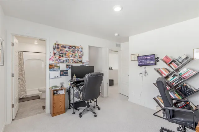 a view of a workspace with furniture and a workspace